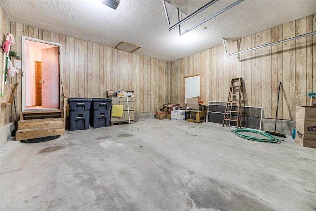 garage featuring wood walls