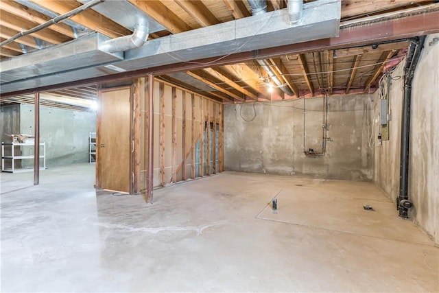 unfinished basement featuring electric panel