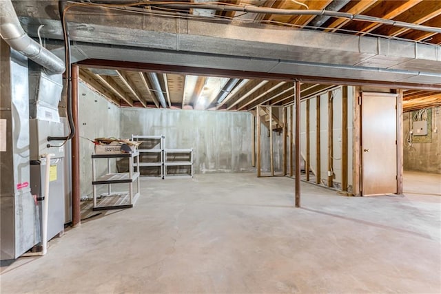 unfinished basement featuring heating unit