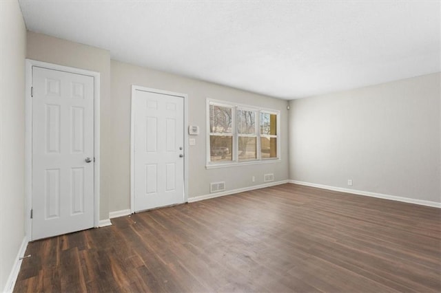 empty room featuring dark hardwood / wood-style flooring