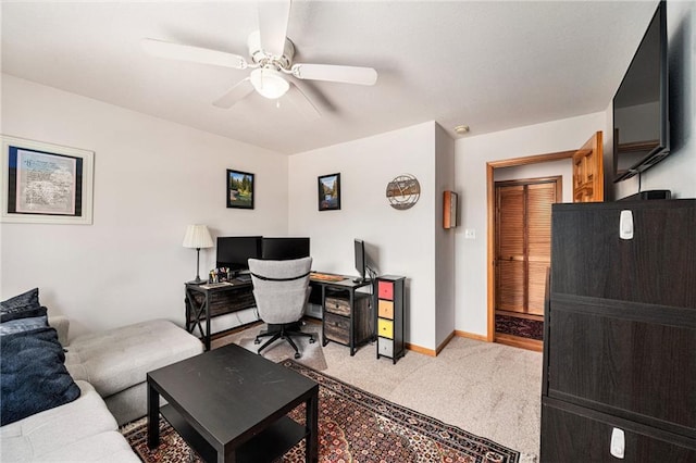 office area with light carpet, ceiling fan, and baseboards