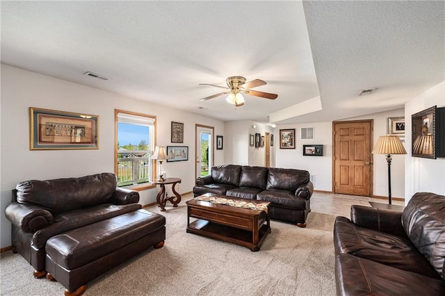living room featuring a ceiling fan, carpet flooring, baseboards, and a textured ceiling