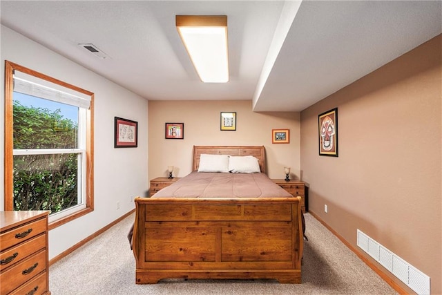 carpeted bedroom featuring baseboards