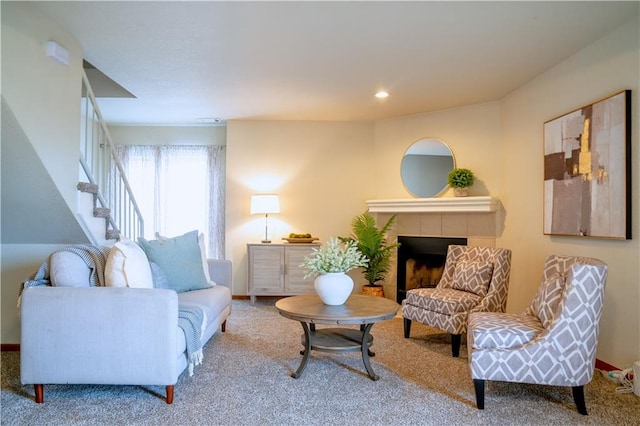 living area featuring carpet, a fireplace, recessed lighting, stairway, and baseboards