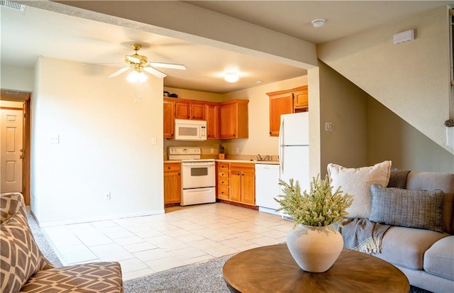 kitchen featuring white appliances, light tile patterned floors, visible vents, light countertops, and a sink