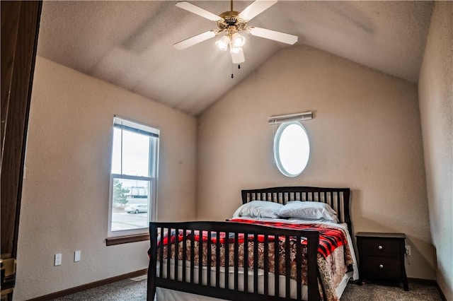 carpeted bedroom with vaulted ceiling, ceiling fan, a textured wall, and baseboards