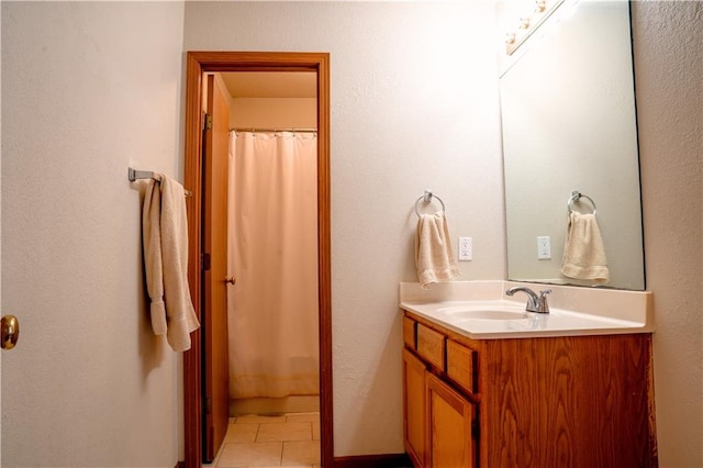 full bath featuring curtained shower, tile patterned flooring, and vanity