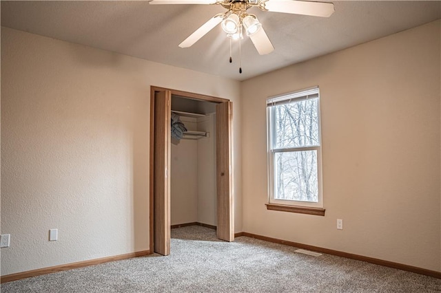 unfurnished bedroom with baseboards, visible vents, a closet, and light colored carpet