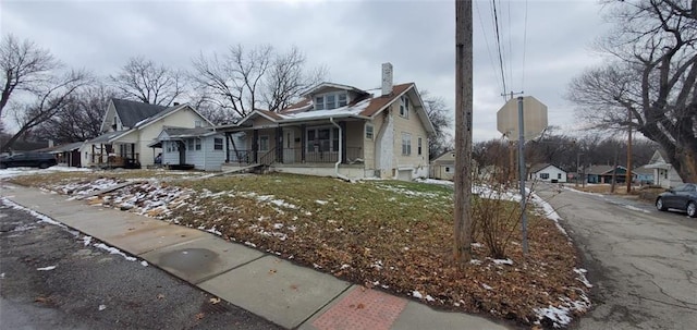 view of side of property featuring covered porch