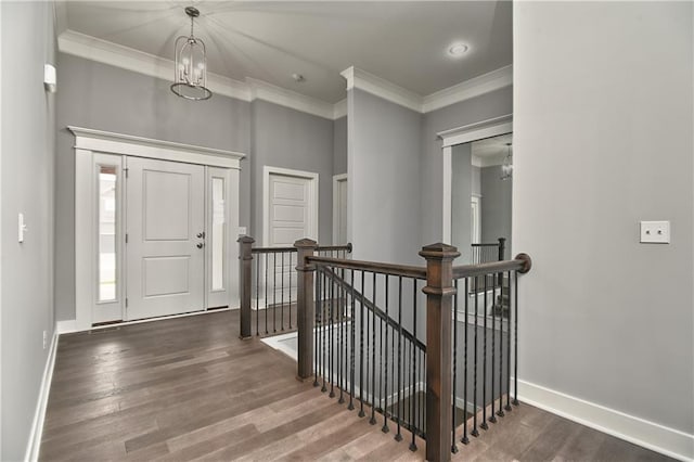 entrance foyer featuring dark wood-type flooring and ornamental molding