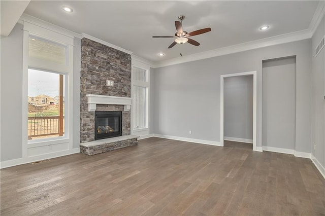 unfurnished living room with dark wood-type flooring, a fireplace, ornamental molding, and ceiling fan