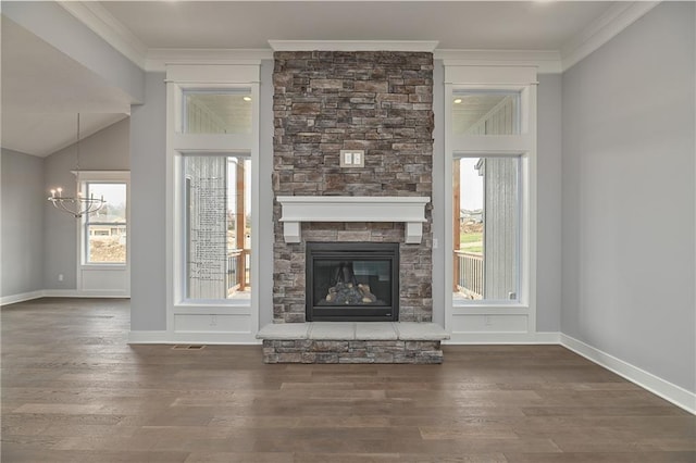 unfurnished living room featuring crown molding, a fireplace, dark hardwood / wood-style floors, and a chandelier