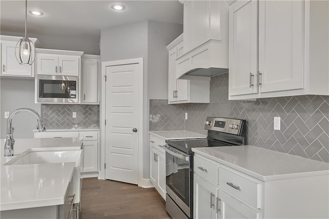 kitchen featuring sink, dark hardwood / wood-style floors, white cabinets, and appliances with stainless steel finishes