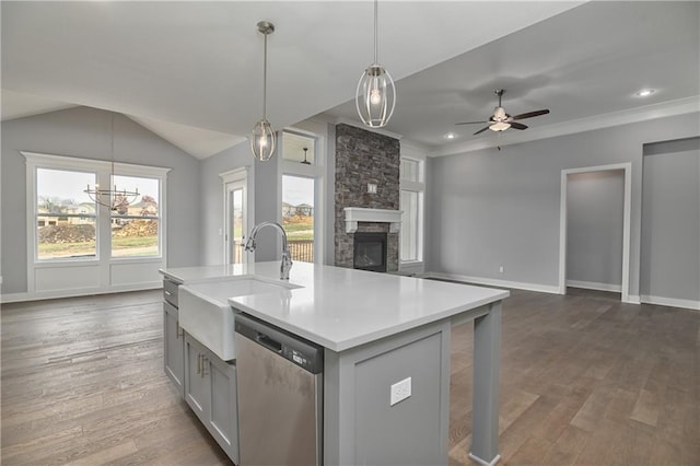 kitchen featuring sink, gray cabinetry, hanging light fixtures, a kitchen island with sink, and stainless steel dishwasher