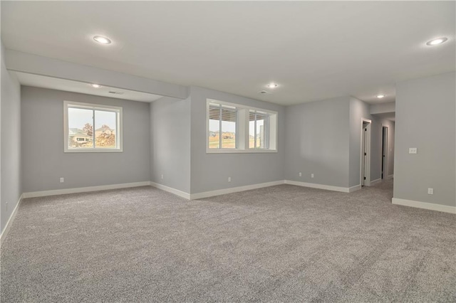 carpeted spare room featuring plenty of natural light