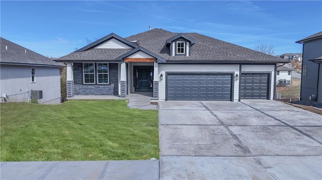 view of front of home with a garage, concrete driveway, a shingled roof, and a front lawn