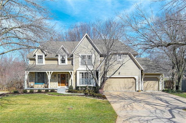 shingle-style home featuring a porch, a front lawn, concrete driveway, a garage, and stone siding