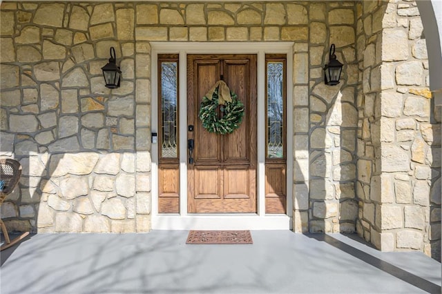 property entrance featuring stone siding