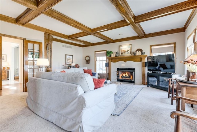 living area with carpet flooring, coffered ceiling, and a glass covered fireplace