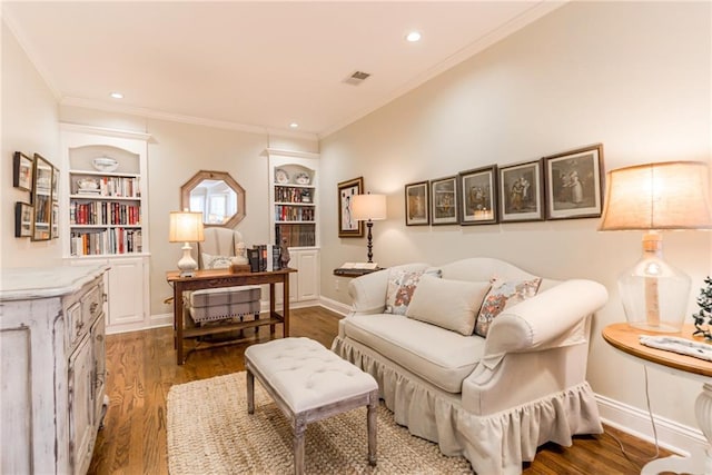 living area featuring built in shelves, wood finished floors, and baseboards