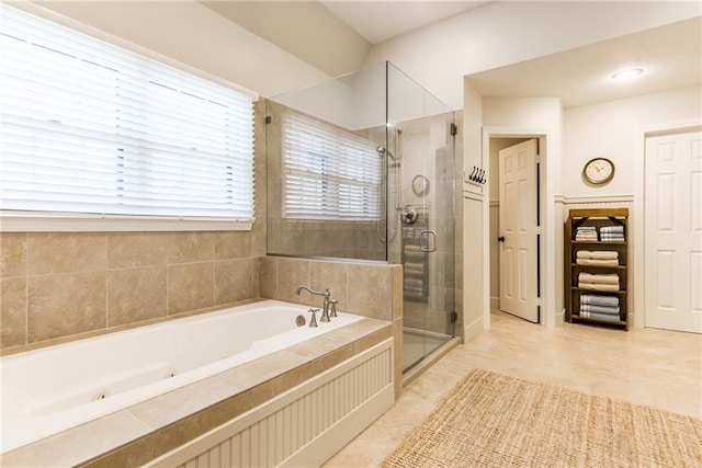 bathroom featuring a bath and a shower stall