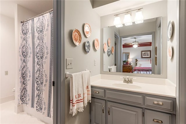 bathroom featuring vanity, a shower with shower curtain, a ceiling fan, and connected bathroom