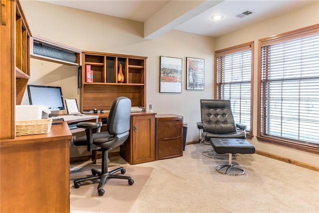 office space featuring visible vents, light carpet, and baseboards