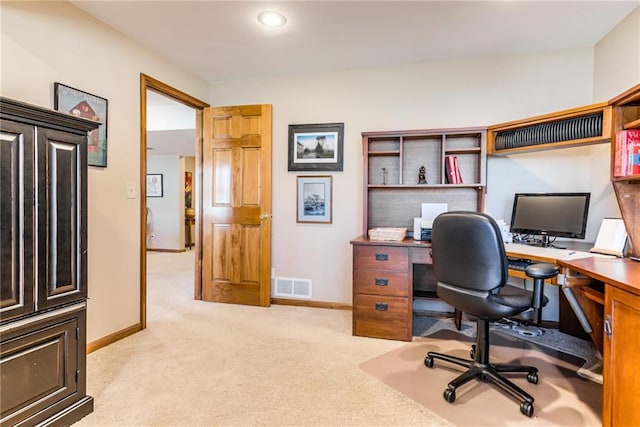 home office featuring visible vents, light carpet, and baseboards