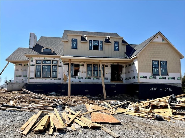 view of front of home with board and batten siding and a chimney