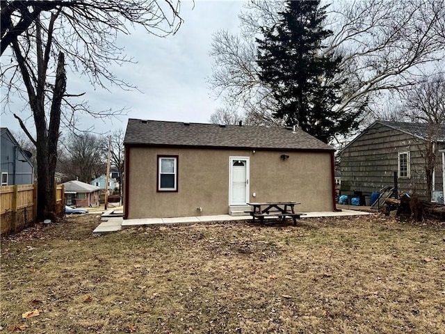 rear view of property with a patio and a lawn