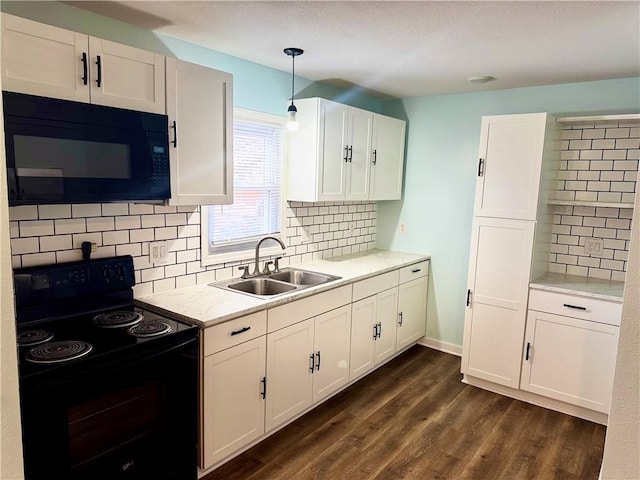 kitchen featuring sink, white cabinetry, decorative light fixtures, dark hardwood / wood-style floors, and black appliances