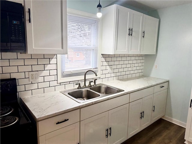 kitchen featuring sink, white cabinets, light stone counters, and black appliances