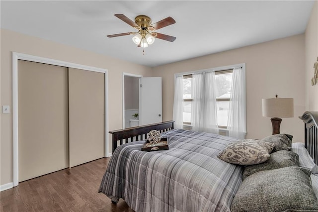 bedroom featuring a closet, wood finished floors, and a ceiling fan