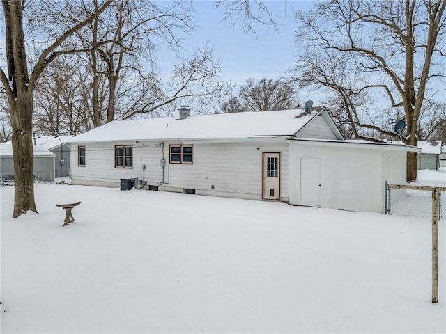 snow covered property featuring fence