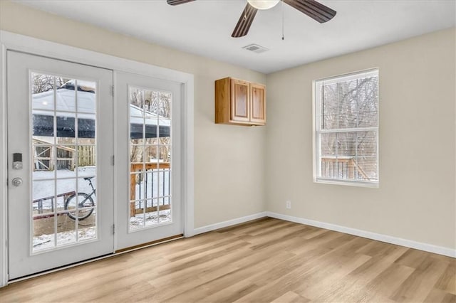 doorway featuring light wood-type flooring and ceiling fan