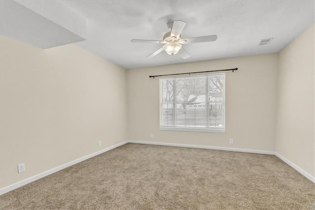 carpeted spare room with ceiling fan