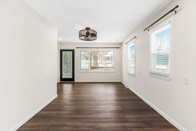 foyer with dark wood-style flooring, recessed lighting, a wealth of natural light, and baseboards