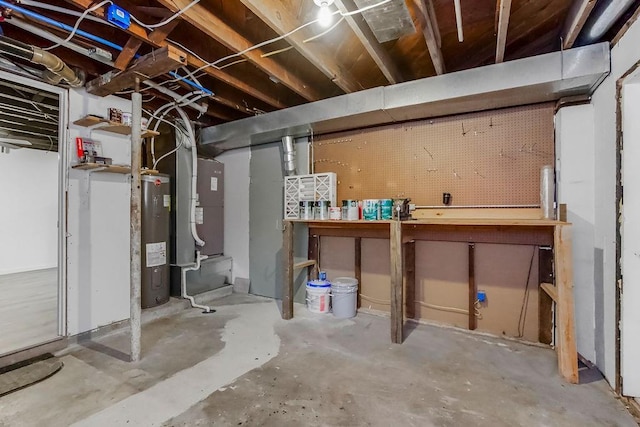 unfinished basement featuring water heater and a workshop area