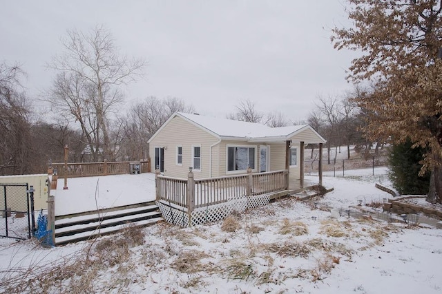 view of front of home featuring fence and a deck