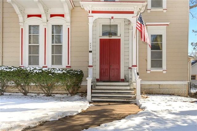 view of snow covered property entrance