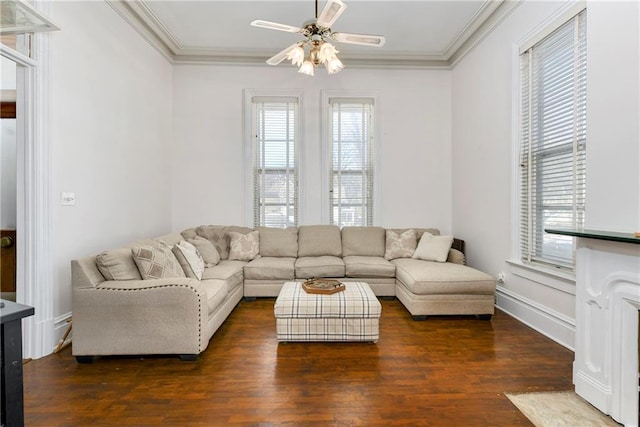 living room featuring dark wood-style floors, ceiling fan, baseboards, and crown molding