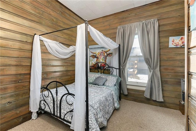 carpeted bedroom featuring wooden walls