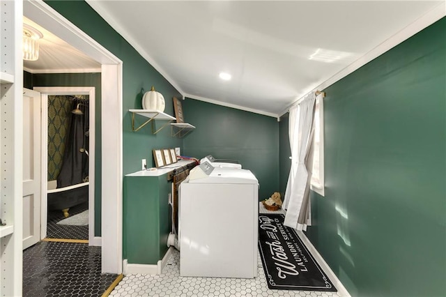 clothes washing area with laundry area, crown molding, baseboards, and washer and dryer