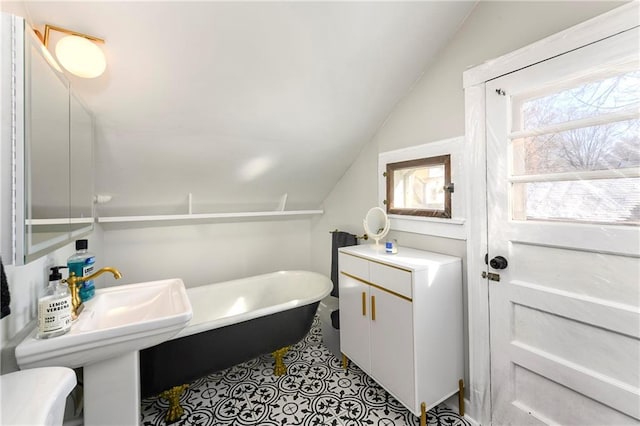 full bath featuring lofted ceiling and a soaking tub