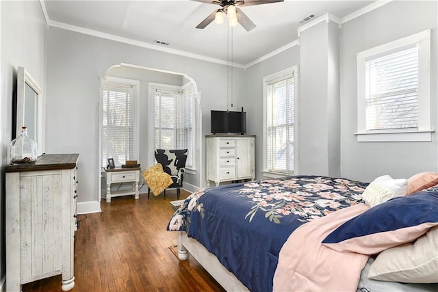 bedroom featuring dark wood-type flooring, visible vents, and crown molding