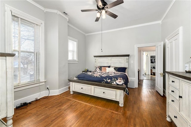 bedroom with ornamental molding, ceiling fan, dark wood-type flooring, and baseboards