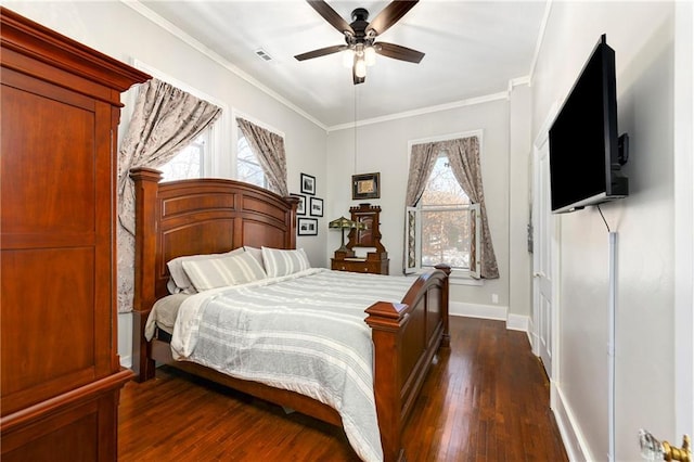 bedroom with dark wood-style flooring, visible vents, crown molding, and baseboards