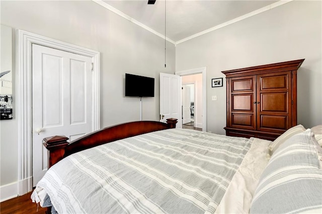 bedroom with ceiling fan, ornamental molding, and wood finished floors