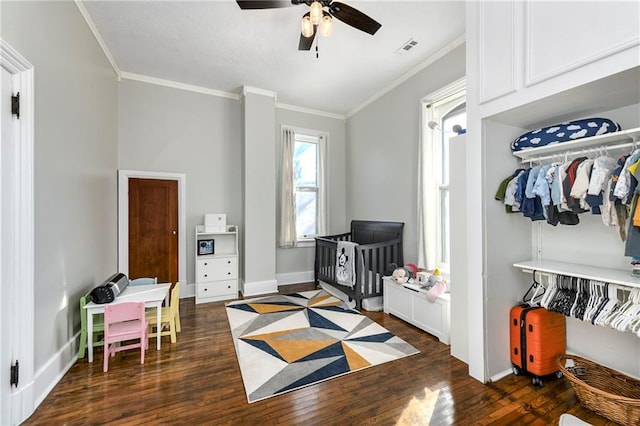 bedroom featuring baseboards, visible vents, ornamental molding, and dark wood-type flooring