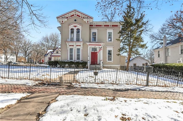 italianate home with entry steps and fence